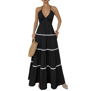 Elegant black halter maxi dress featuring a high waist and tiered white wavy lace hem