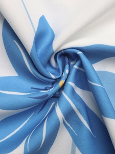 Macro detail of the light blue floral print on high-quality white polyester fabric
