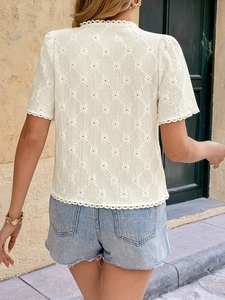Rear view of off-white short sleeve blouse with diamond hollow pattern and lace details