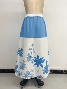 Detailed view of sky blue and white patchwork floral maxi skirt with elastic waistband