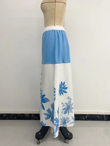 Detail of high-waist A-line long skirt with sky blue satin and floral print patchwork