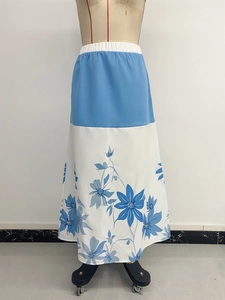 Detail of high-waisted floral print maxi skirt featuring elastic waist and patchwork design