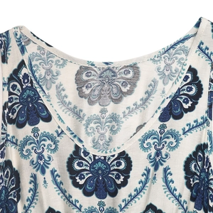 Close-up of the bohemian paisley print on a white sleeveless dress with a V-neckline