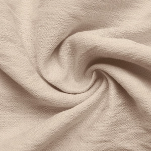 Macro shot of beige fabric texture with fine grain and subtle silk-like luster