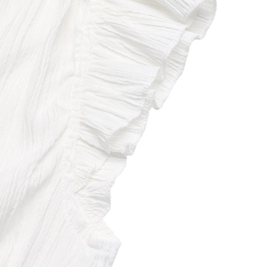 Close-up of white pleated chiffon fabric featuring elegant ruffle layers and textures