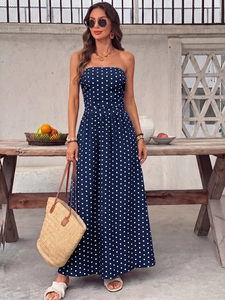 Close-up of elegant navy blue strapless maxi dress with classic white polka dot patterns
