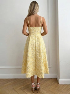 Detail of elegant backless summer dress with floral jacquard texture and thin straps
