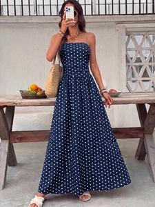 Detailed texture of navy blue strapless maxi dress with white polka dots for summer