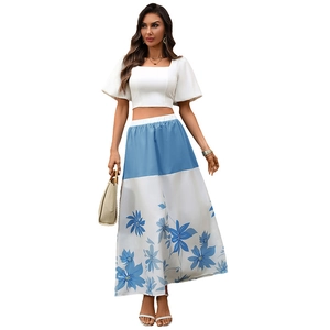 Women's summer two-piece set featuring a white puff sleeve crop top and blue floral maxi skirt
