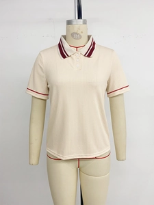 Detail of knit polo shirt with red stripes on ribbed collar and three-button placket
