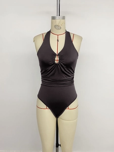 Detail view of coffee halter neck bodysuit with metal ring and pleated waist texture