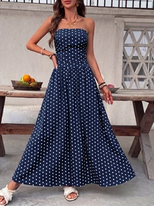 Detail of navy blue polka dot strapless maxi dress with elastic smocked waist design