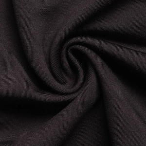 Detailed macro view of the premium black knit fabric with elegant draped texture