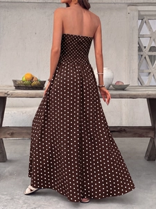 Detail of smocked back design on elegant brown polka dot strapless summer maxi dress