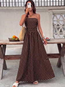 Detail of the elegant brown polka dot strapless maxi dress with a vintage A-line design