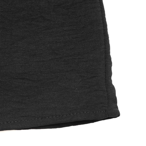 Detail shot of the black fabric texture and neat single-needle stitching on the hemline