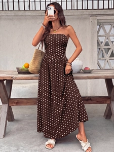 Detail of coffee brown polka dot strapless maxi dress with elastic smocked waistline