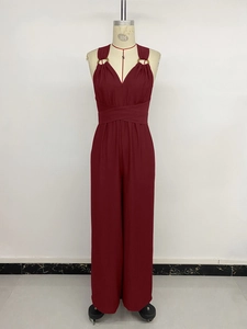 Detail of dark red sleeveless jumpsuit with gold ring accents and elegant V-neck design