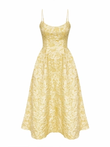 Close-up of the elegant jacquard fabric texture on the pale yellow backless summer dress