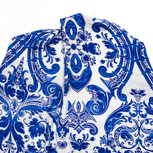 Detail of blue and white baroque majolica print fabric on backless halter dress