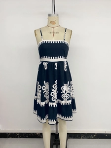 Detail of floral embroidery and layered ruffles on a black backless sundress
