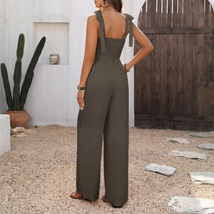 Detail of bohemian dark grey jumpsuit featuring smocked back and adjustable bow straps