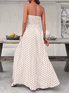 Detail of the elastic shirred bodice and polka dot print on an elegant maxi dress