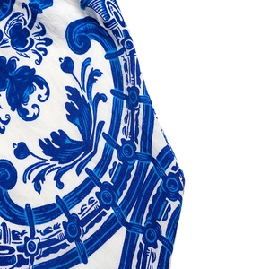 Detailed macro view of the vintage blue floral print on high-quality linen fabric