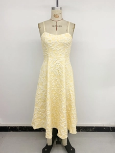 Detailed view of the 3D jacquard floral fabric on a light yellow summer camisole dress