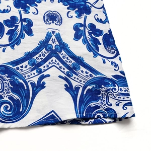 Detailed view of blue floral print fabric and neat hem stitching on the maxi dress