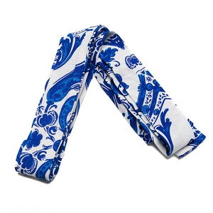 Macro shot of satin scarf with blue and white Baroque tile pattern for handbags