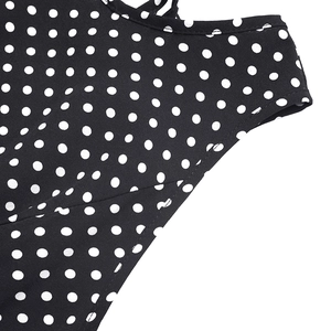 Détails des coutures soignées et du motif à pois blancs sur la robe d'été noire