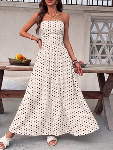 Detail of white strapless polka dot maxi dress with high waist and flared skirt hem