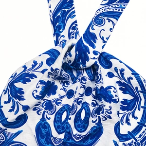 Detailed macro view of the blue paisley print and fabric texture on a halter neck dress