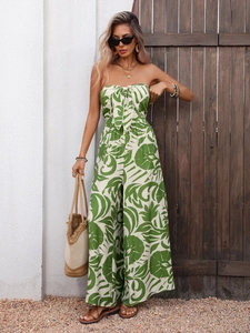 Detail of tropical print jumpsuit featuring a front bow tie and wide-leg cut design