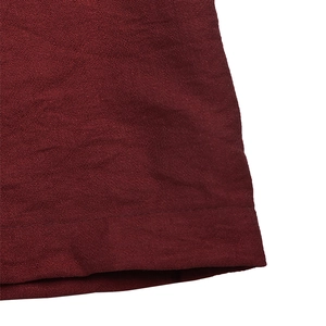 Macro detail of the wine red chiffon fabric texture and high-quality hem stitching