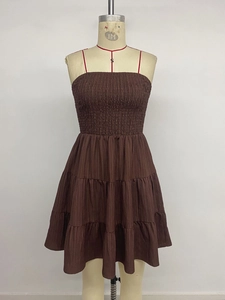 Close-up of smocked bodice and tiered hem on a brown strapless summer dress