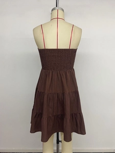 Detail of smocked elastic back and red spaghetti straps on brown tiered sun dress
