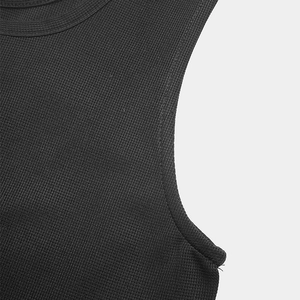 Close-up of the vertical knit texture and reinforced armhole stitching on a black romper