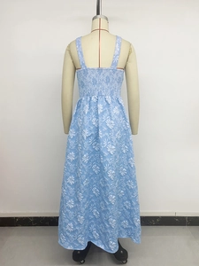 Detail of smocked elastic back and white floral pattern on a light blue summer dress