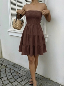 Detail of smocked strapless bodice and tiered mini skirt in deep coffee brown color