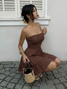 Detail of smocked dark brown strapless mini dress with tiered ruffle hem and texture