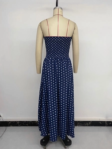 Detailed back view of navy polka dot maxi dress with smocked elastic panel on mannequin