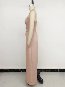Detail of smocked elastic bodice and waist tie on pink wide-leg jumpsuit