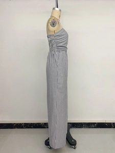 Side view of vertical black and white striped tube top jumpsuit on a mannequin