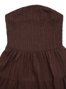 Detail view of chocolate brown smocked tube dress with elastic pleated fabric texture