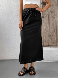 Detailed view of black maxi skirt featuring elastic drawstring waist and textured fabric
