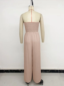Detailed back view of dusty pink wide leg jumpsuit with smocked elastic back design