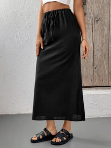 Detailed close-up of a black long skirt featuring a high-waisted drawstring and linen texture