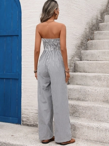 Detail showing back of women's striped strapless wide-leg jumpsuit with smocked texture